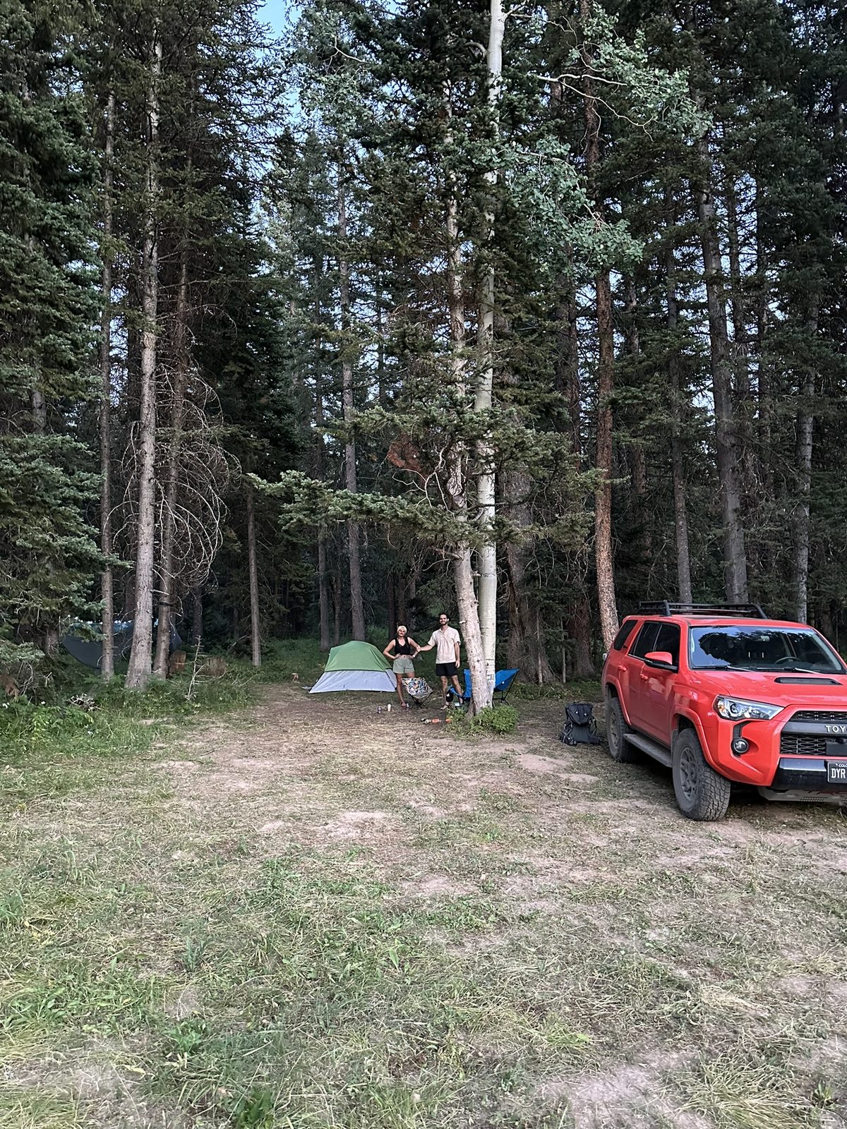 Tent and truck at a forest campsite