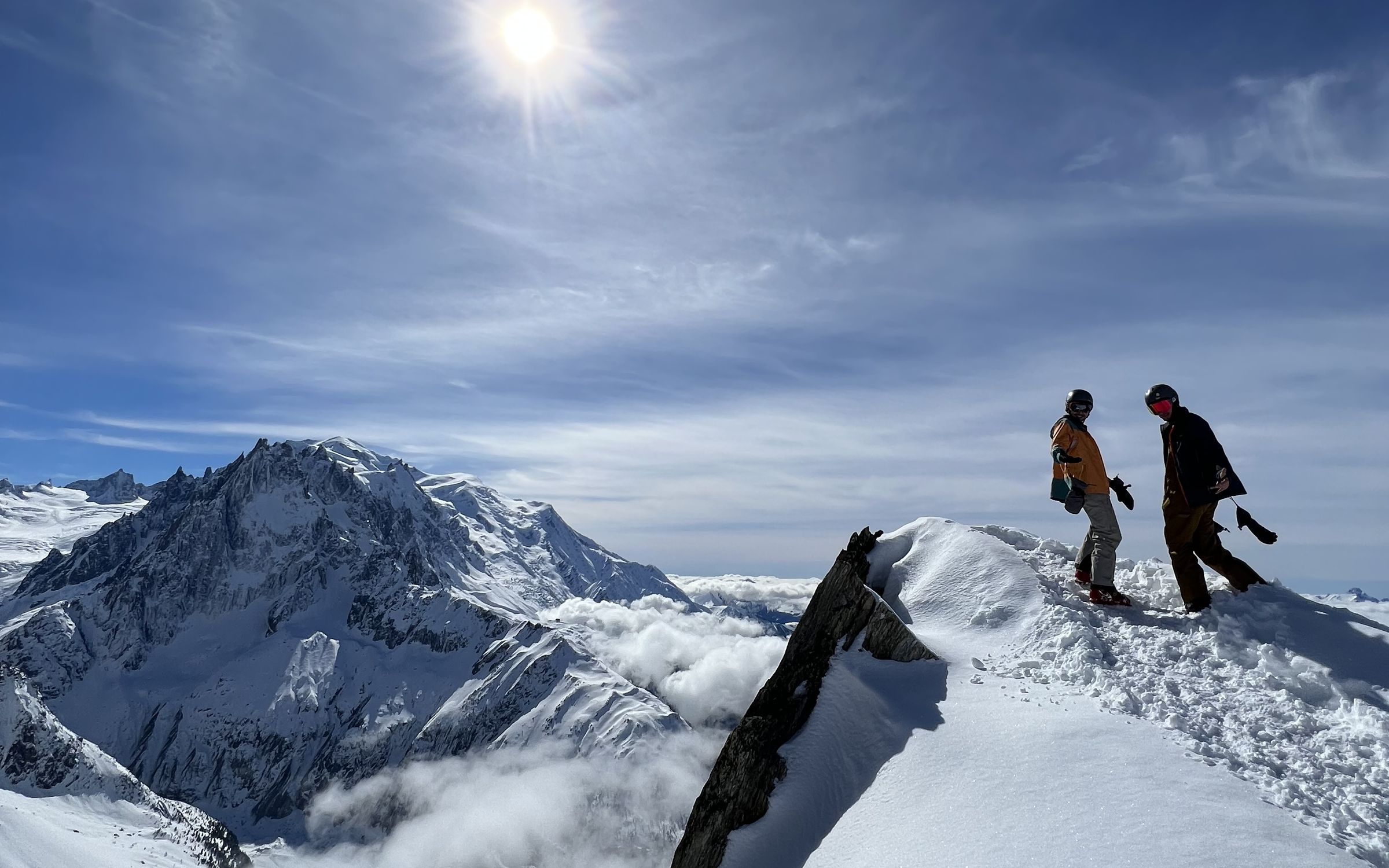 Two skiers on a snowy ridge above Chamonix
