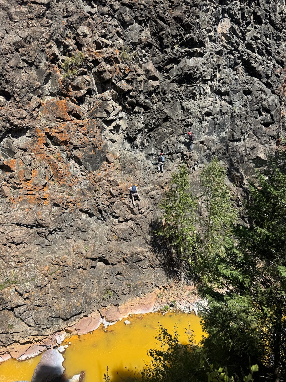 Looking down a via ferrata rock wall